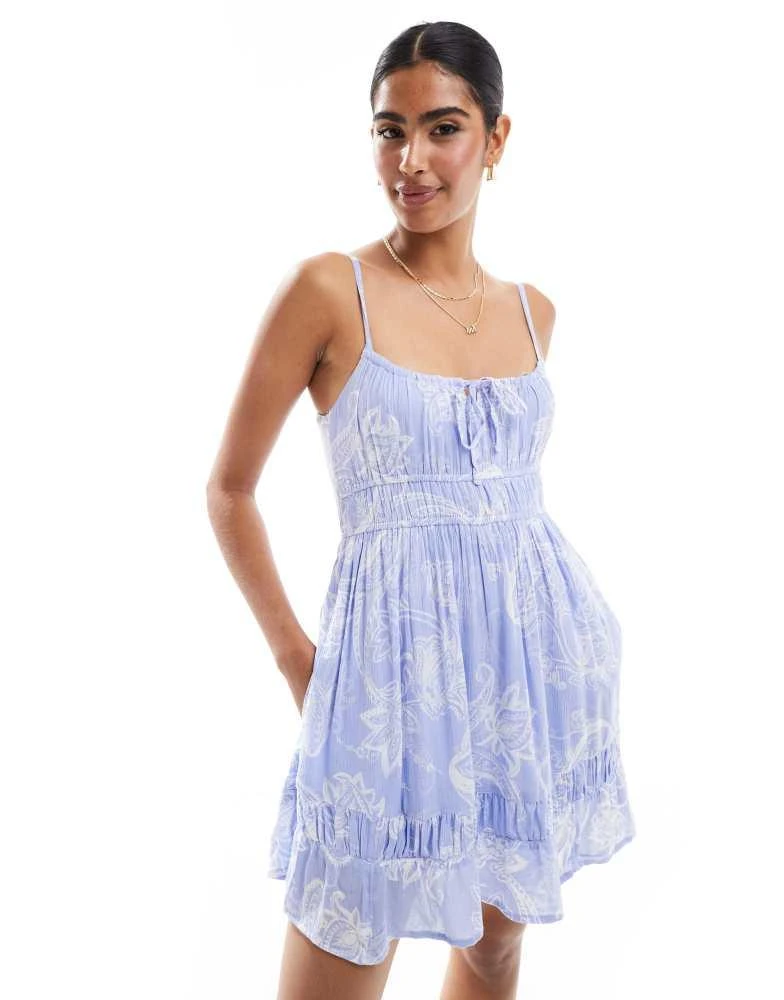 HOLLISTER Hollister shirred detail tie back short dress with shirred bust detail in blue paisley print 1