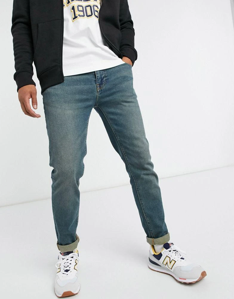 ASOS ASOS DESIGN skinny jeans in vintage mid wash blue 4