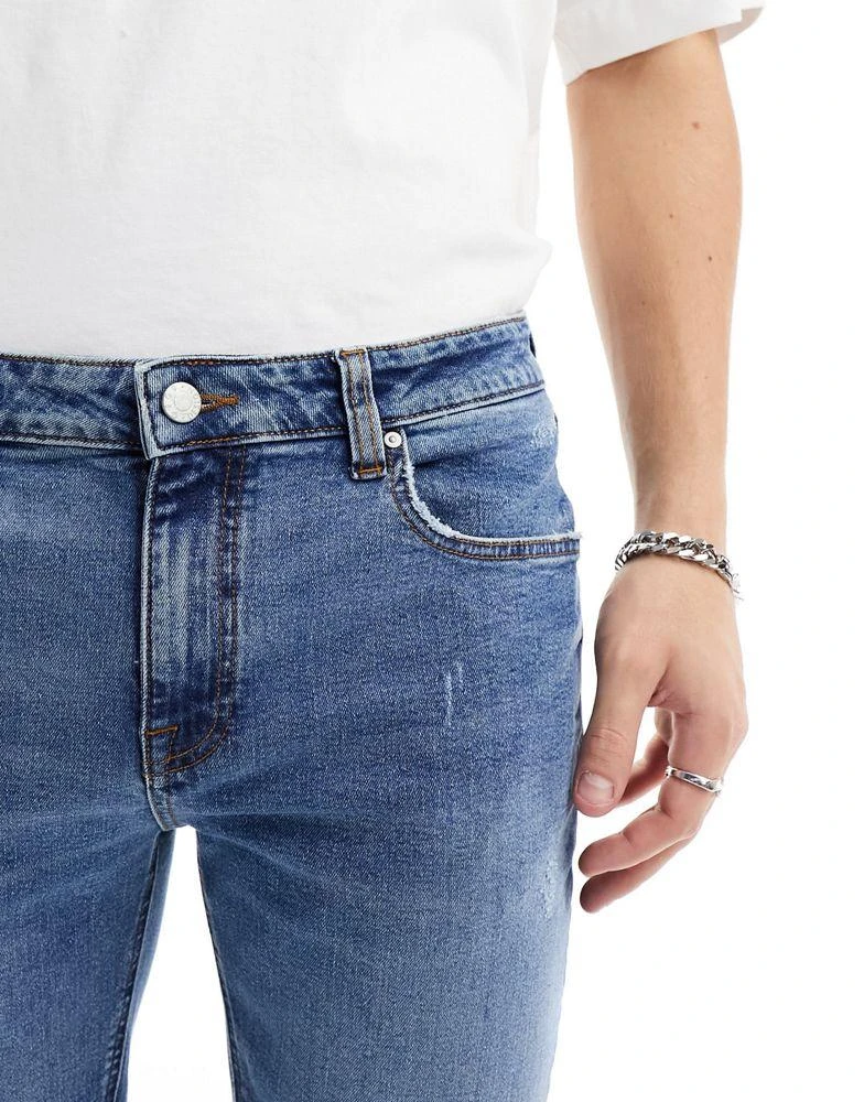 ASOS ASOS DESIGN skinny jeans with knee rip in dark wash blue 4