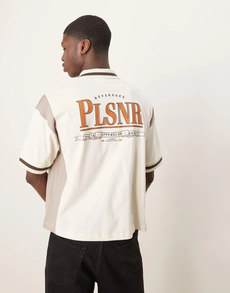 ASOS ASOS DESIGN boxy oversized zipped polo with cut and sew panelling and text graphic in cream 1