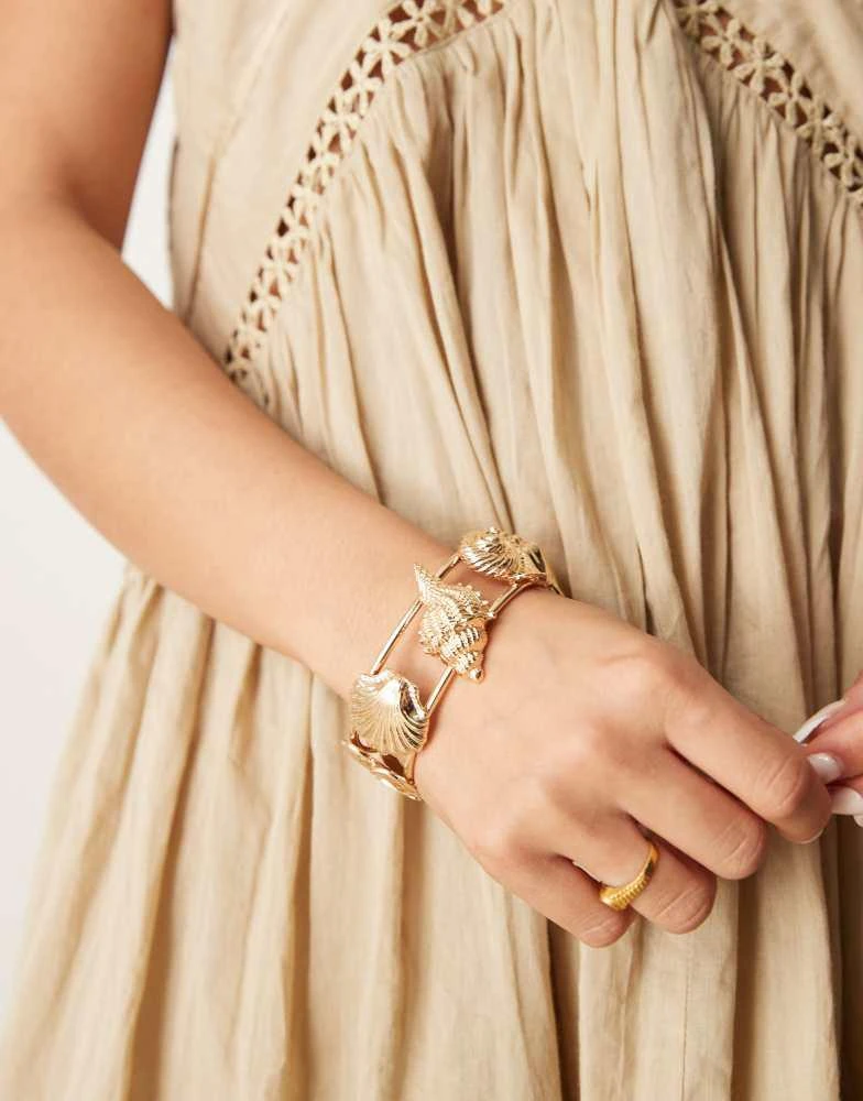 ASOS ASOS DESIGN cuff bracelet in mixed shell design in gold tone 1
