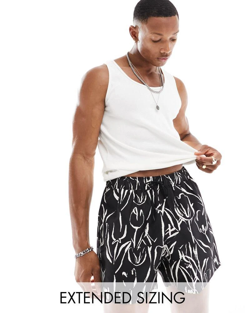 ASOS ASOS DESIGN swim shorts in short length in black and white floral print 1