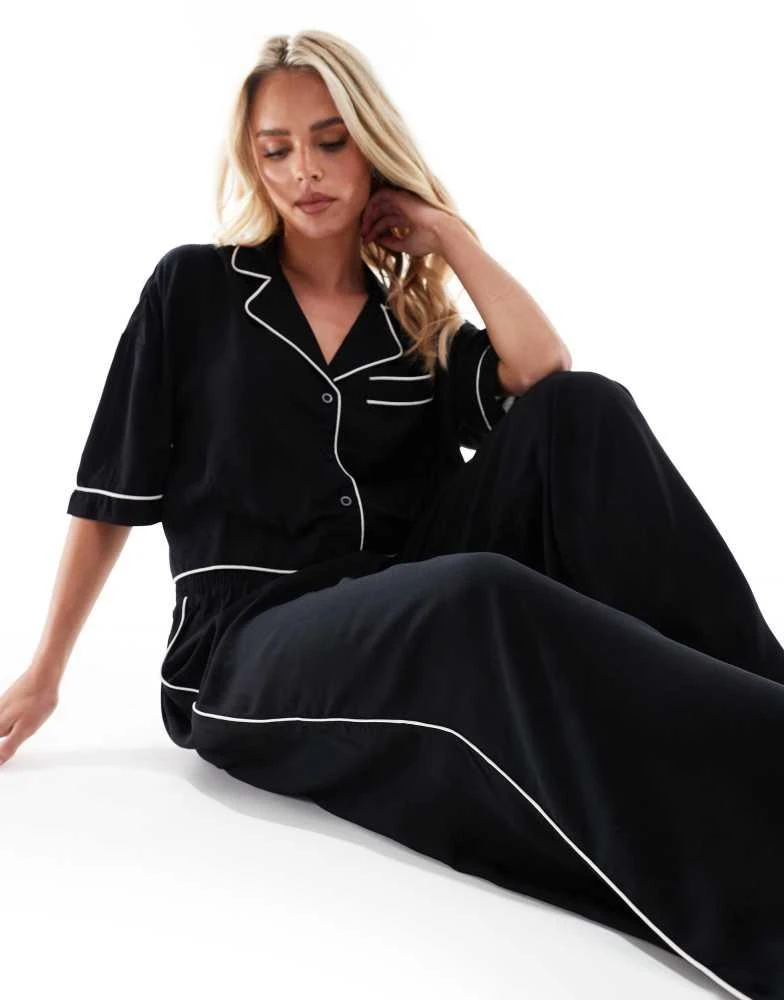 ASOS ASOS DESIGN Petite super soft slinky wide leg pyjama trouser in black with contrast binding 2