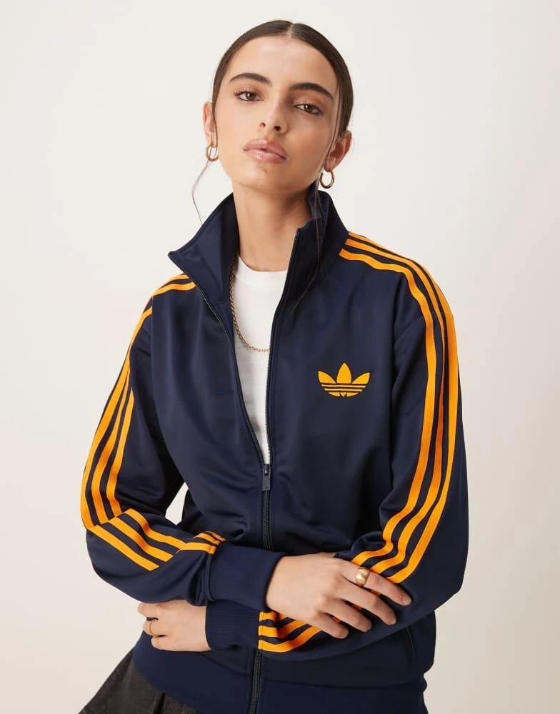 Adidas adidas Originals Firebird Loose track top in navy and orange 1