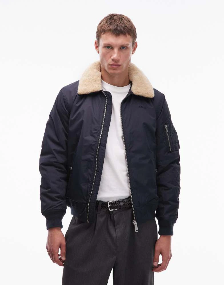 Schott Schott logo patch zip pocket detail cropped padded jacket with faux fur collar in navy