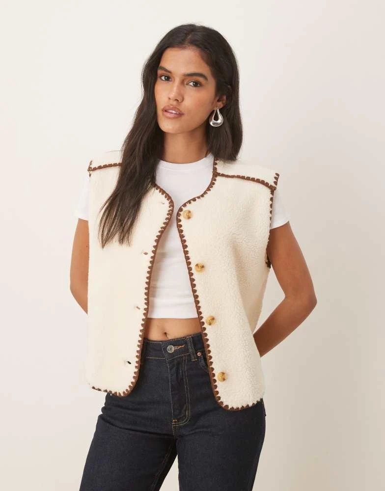 Shop ASOS DESIGN borg fleece gilet with blanket stitch in cream