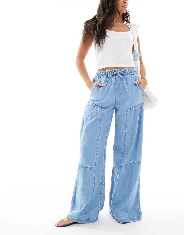 ASOS ASOS DESIGN soft wide leg pull on jean with stitch detail in mid blue 1